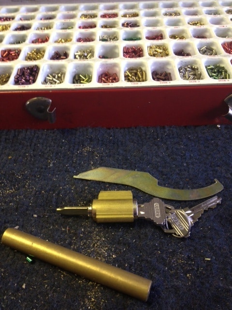 image of a lock cylinder that's been removed from the lock so the pins can be replaced to work with a new key